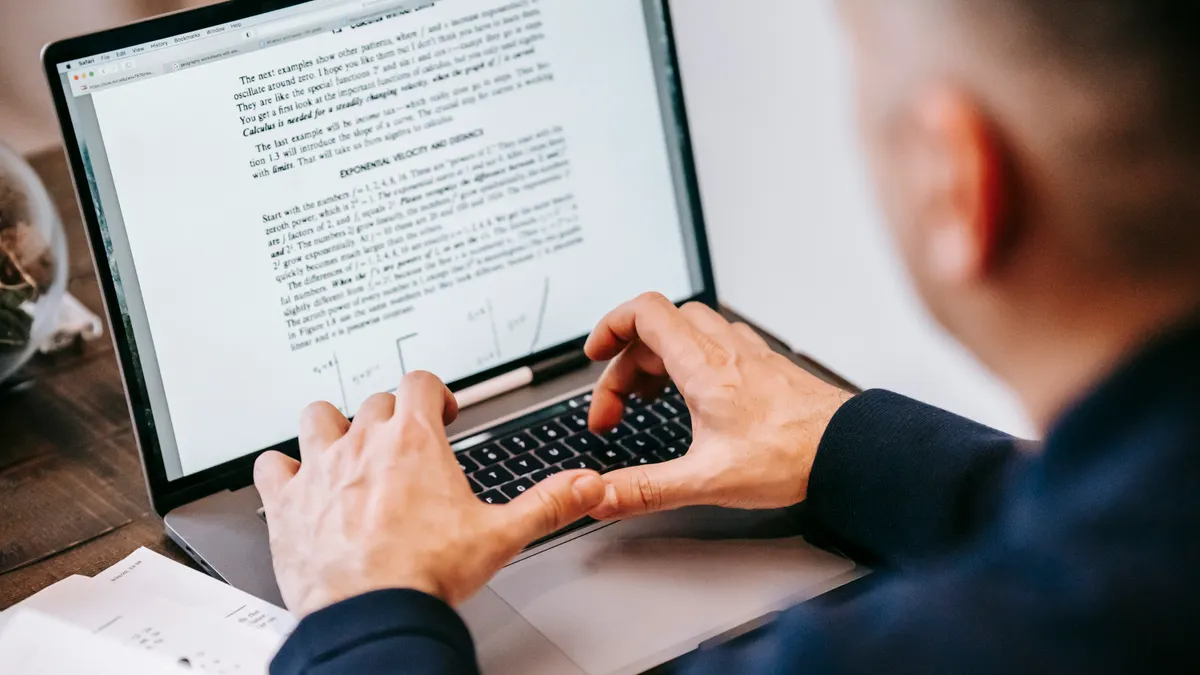 person editing a text document on a laptop