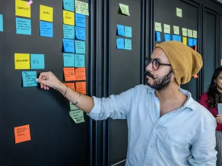 team placing sticky notes on a planning board