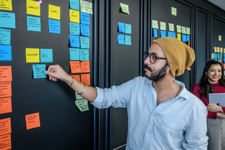 team placing sticky notes on a planning board