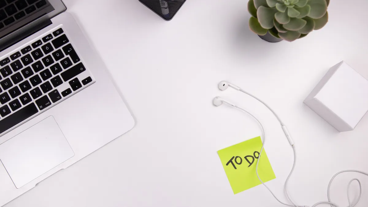 Desk with laptop and a to-do note, symbolizing task management